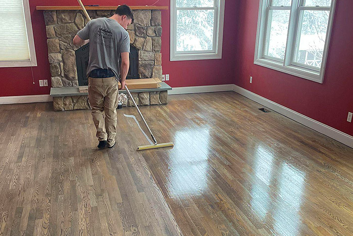 man cleaning hardwood floor